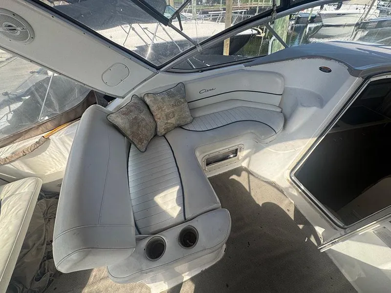 Slide: The Image of 2001 Bayliner 2855 LX Sunbridge interior with white seating and decorative pillows. - 16