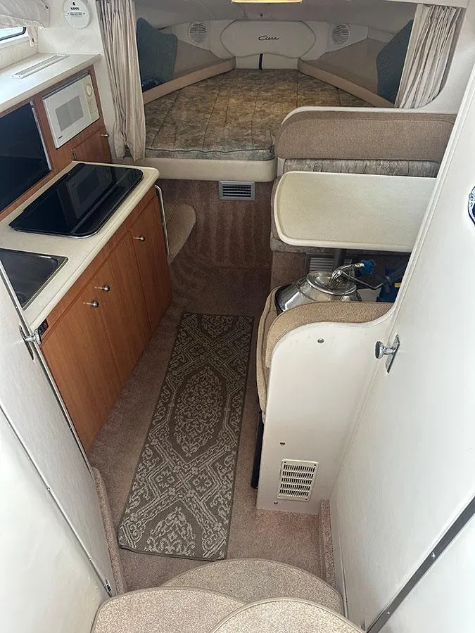 Slide: The Image of Interior of 2001 Bayliner 2855 LX Sunbridge with kitchenette and sleeping area. - 9