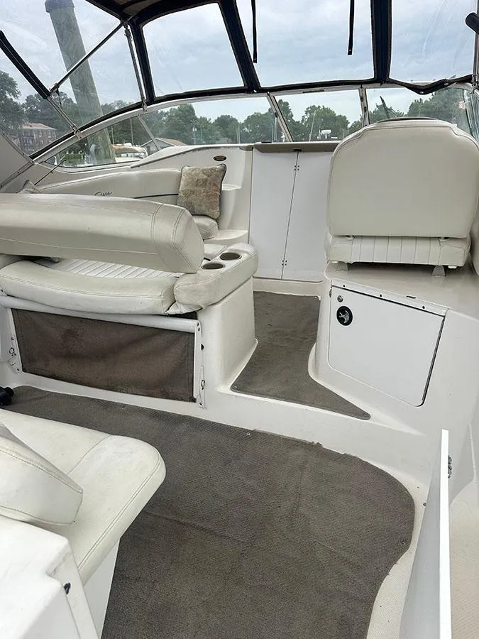 Slide: The Image of 2001 Bayliner 2855 LX Sunbridge interior with white seating and carpeted floor. - 19