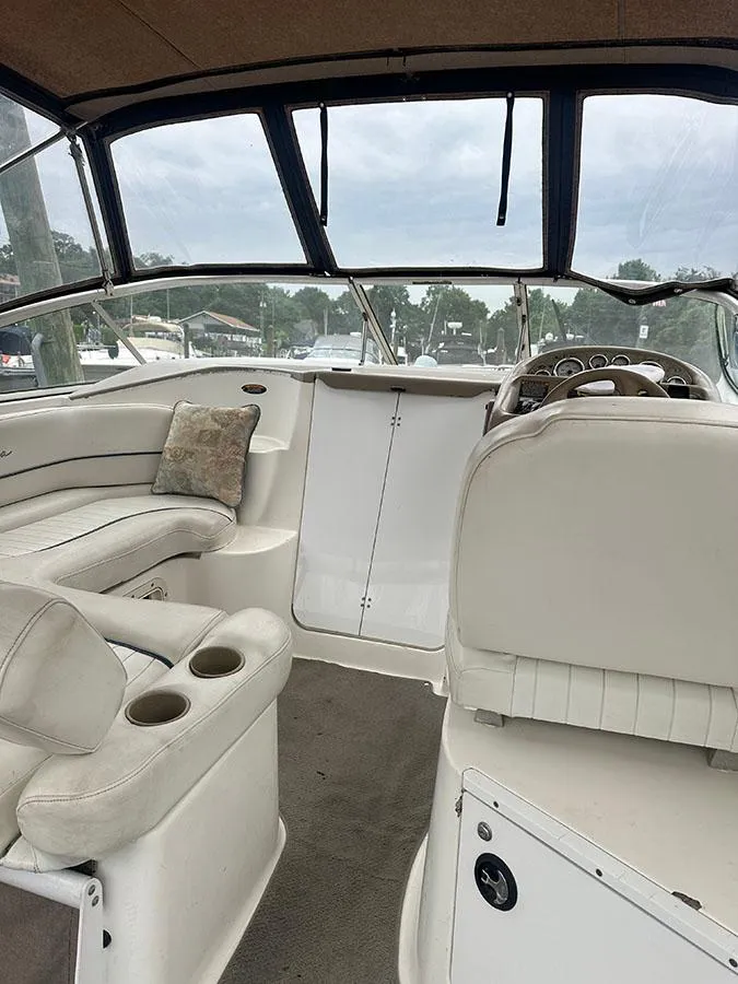 Slide: The Image of 2001 Bayliner 2855 LX Sunbridge interior with white seating and dashboard view. - 20