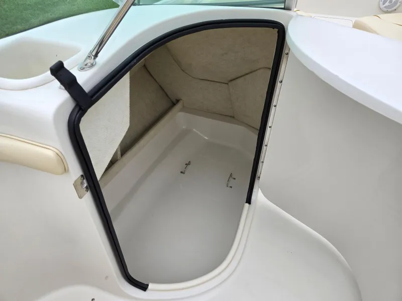 Slide: The Image of Storage compartment on a 2001 Sea Ray 210 Sundeck boat, open and empty. - 11