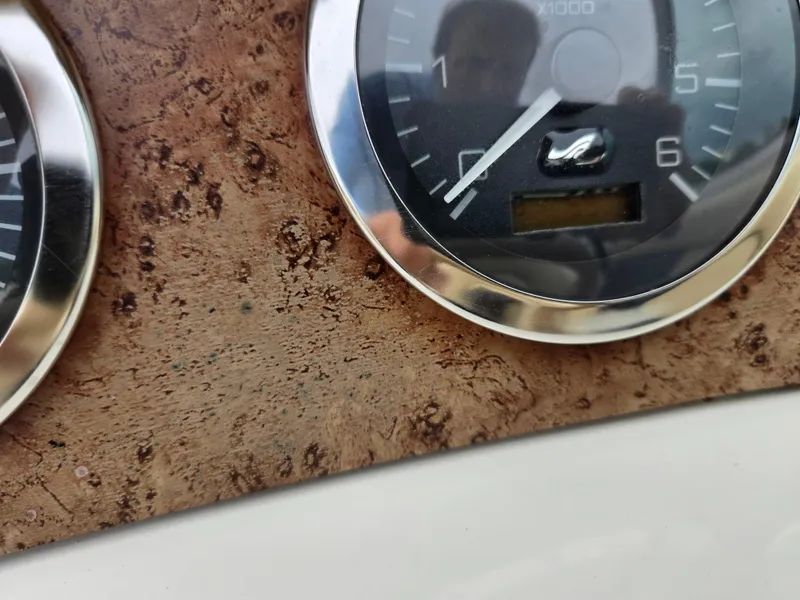Slide: The Image of Close-up of 2001 Sea Ray 210 Sundeck dashboard with wood grain and gauges. - 13