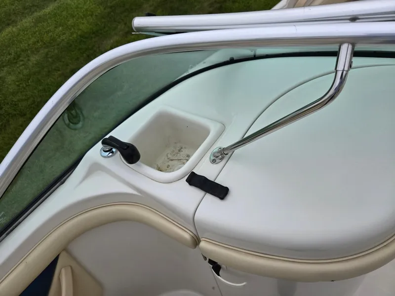 Slide: The Image of 2001 Sea Ray 210 Sundeck boat interior detail with windshield and storage compartment. - 14