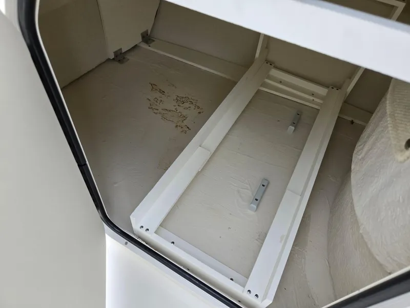 Slide: The Image of Storage compartment of a 2001 Sea Ray 210 Sundeck boat, showing interior details. - 15