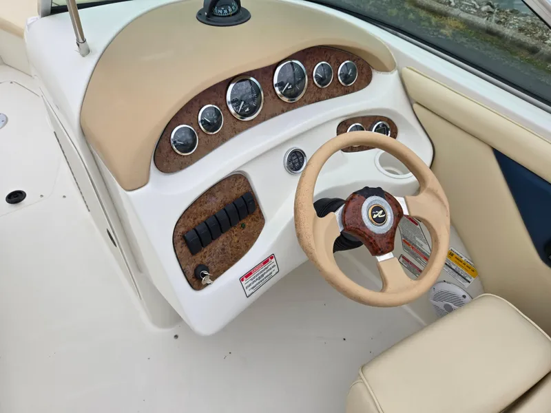 Slide: The Image of 2001 Sea Ray 210 Sundeck dashboard with gauges and steering wheel. - 16