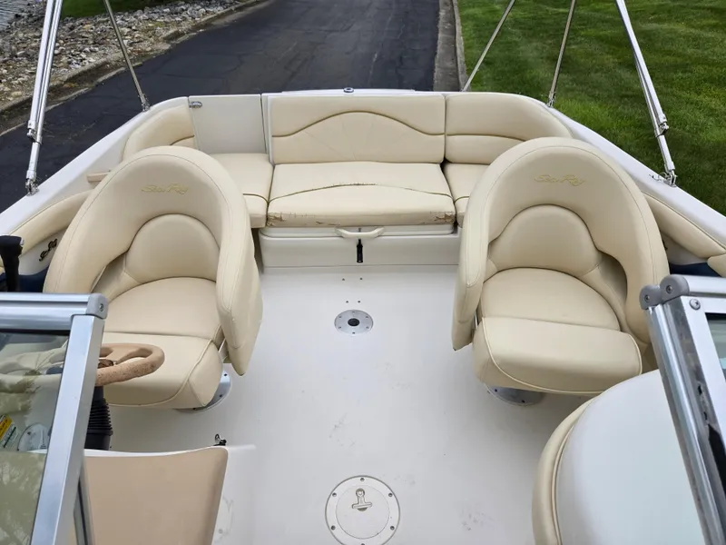 Slide: The Image of 2001 Sea Ray 210 Sundeck interior with beige seating and open deck layout. - 21