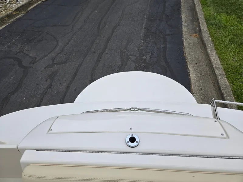 Slide: The Image of 2001 Sea Ray 210 Sundeck boat, rear view, parked on asphalt road. - 24