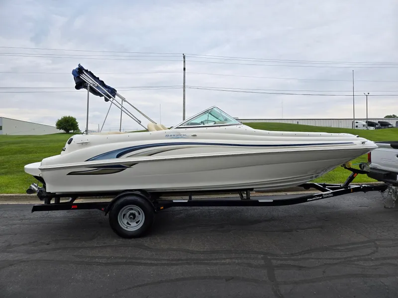 Slide: The Image of 2001 Sea Ray 210 Sundeck boat on trailer, side view, outdoors. - 4