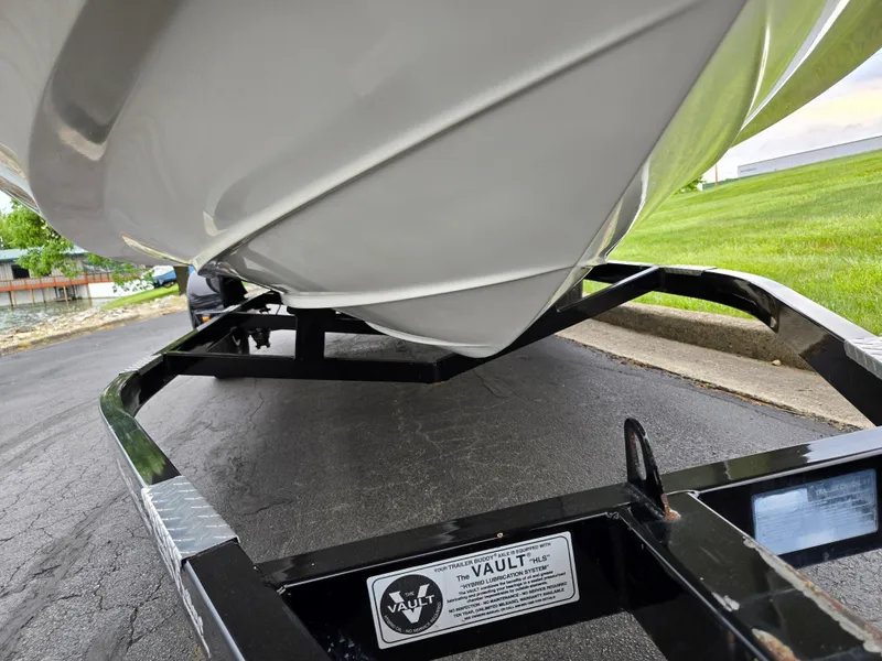 Slide: The Image of 2001 Sea Ray 210 Sundeck boat on trailer, close-up view of hull and trailer. - 7