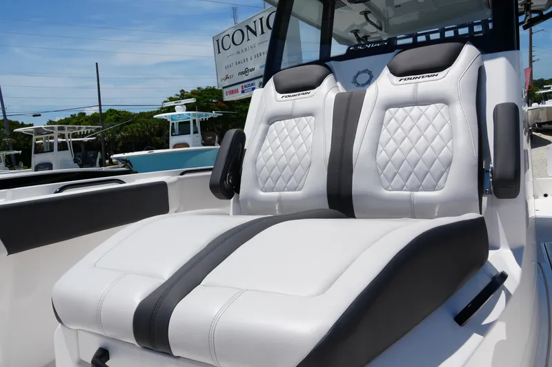 Slide: The Image of 2025 Fountain 32NX boat seats with diamond stitching, displayed at a marine dealership. - 10