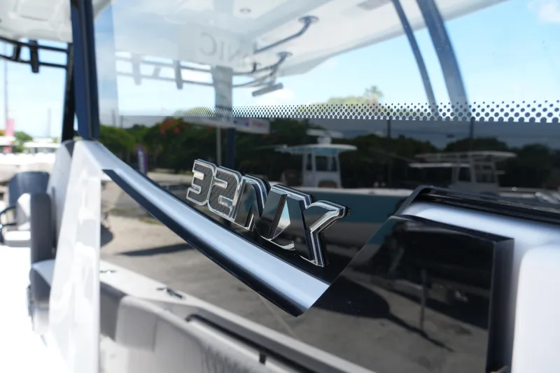 Slide: The Image of 2025 Fountain 32NX boat, close-up of model emblem on sleek exterior. - 12
