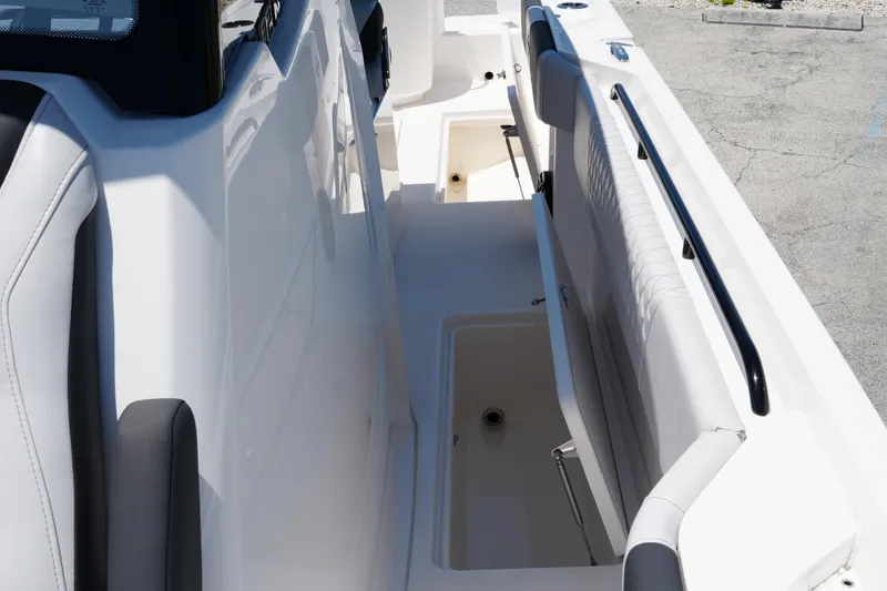 Slide: The Image of 2025 Fountain 32NX boat interior with open storage compartments and seating. - 15