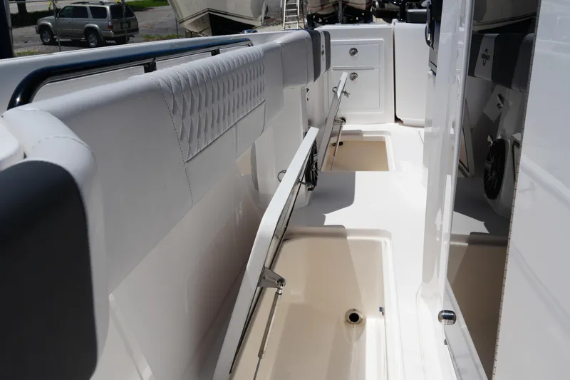 Slide: The Image of 2025 Fountain 32NX boat interior with storage compartments and cushioned seating. - 16