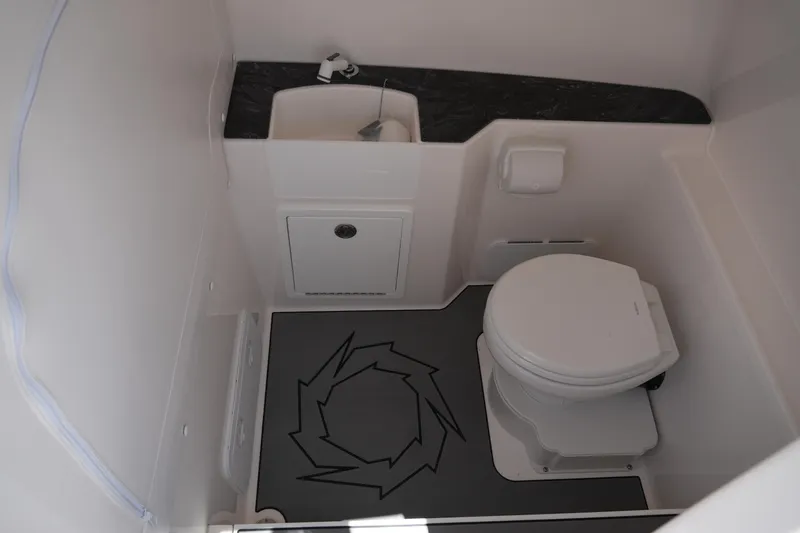 Slide: The Image of Compact bathroom in 2025 Fountain 32NX boat with toilet and sink. - 23