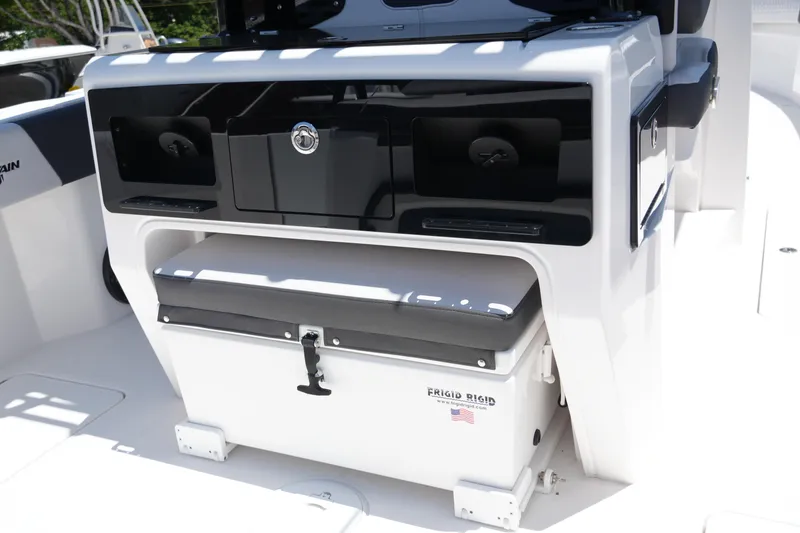 Slide: The Image of 2025 Fountain 32NX boat interior with storage compartment and Frigid Rigid cooler. - 27