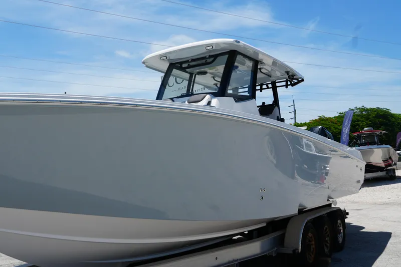 Slide: The Image of 2025 Fountain 32NX boat on trailer under clear blue sky. - 4