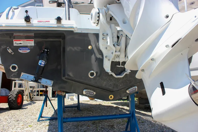 Slide: The Image of 2026 Sea Hunt Ultra 245 SE boat on stands, showcasing the stern and outboard motor. - 10