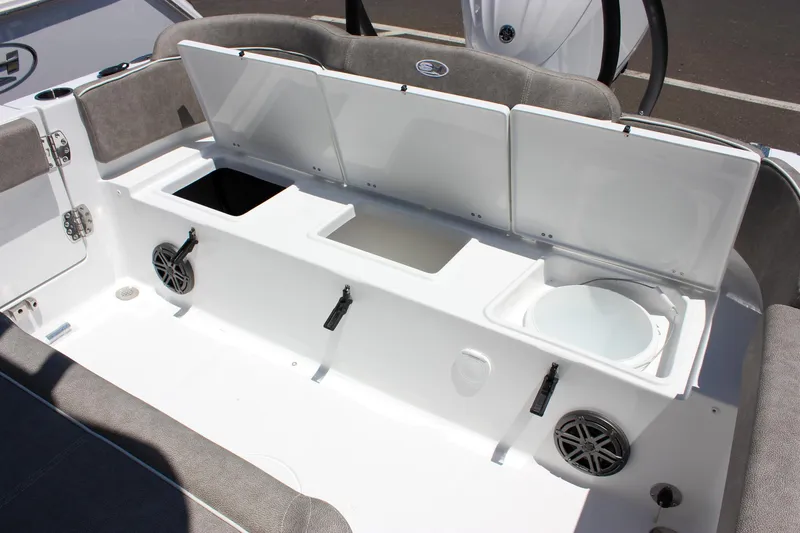Slide: The Image of 2026 Sea Hunt Ultra 245 SE boat interior with storage compartments and speakers. - 16