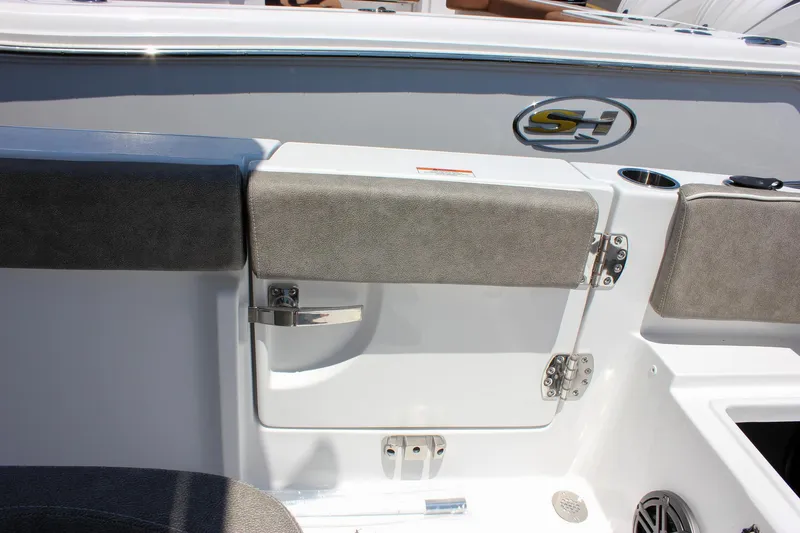Slide: The Image of 2026 Sea Hunt Ultra 245 SE boat interior with cushioned seating and storage compartment. - 17