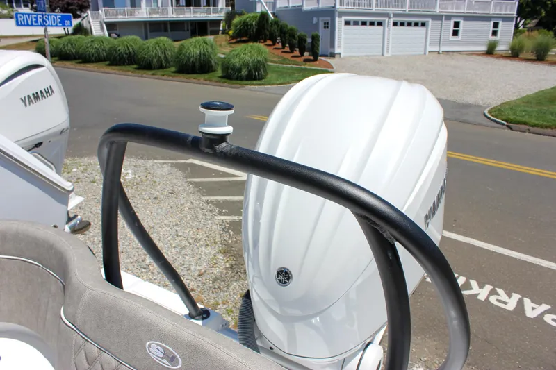 Slide: The Image of 2026 Sea Hunt Ultra 245 SE boat with Yamaha engine, parked near Riverside Drive. - 18