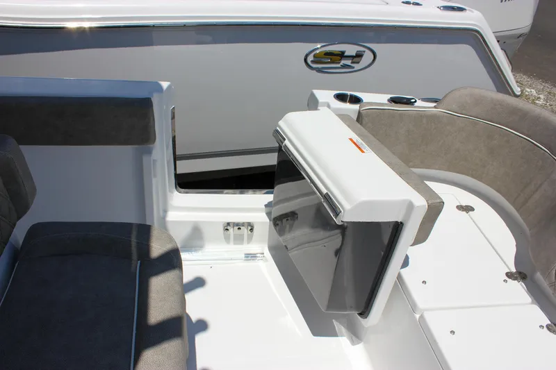 Slide: The Image of 2026 Sea Hunt Ultra 245 SE boat interior with seating and storage compartment. - 19