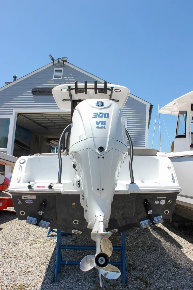 Slide: The Image of 2026 Sea Hunt Ultra 245 SE boat with Yamaha 300 V6 engine, displayed outdoors. - 2