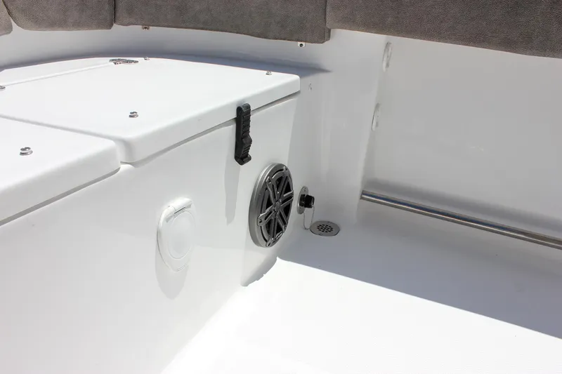 Slide: The Image of 2026 Sea Hunt Ultra 245 SE boat interior with speaker and storage compartment. - 23