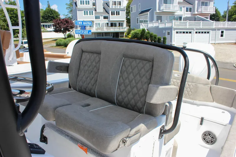 Slide: The Image of 2026 Sea Hunt Ultra 245 SE boat seat with diamond-stitched upholstery, dockside view. - 25