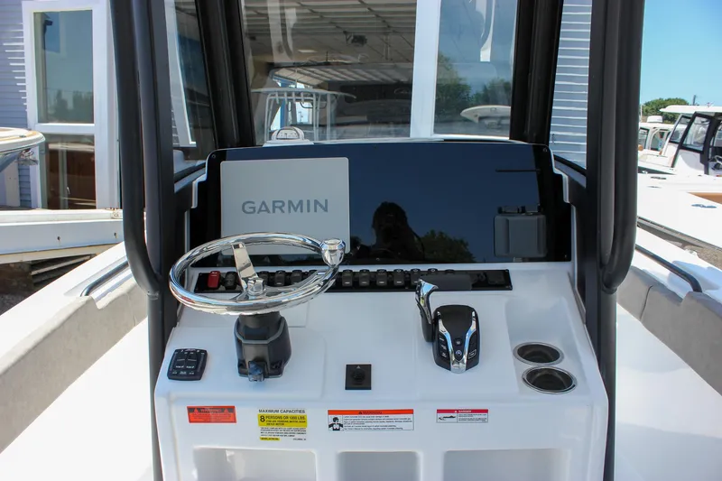 Slide: The Image of 2026 Sea Hunt Ultra 245 SE boat dashboard with Garmin navigation system and steering wheel. - 3