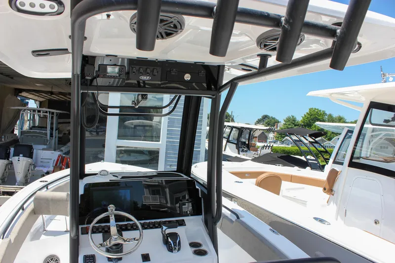 Slide: The Image of 2026 Sea Hunt Ultra 245 SE boat interior with steering wheel and control panel. - 32