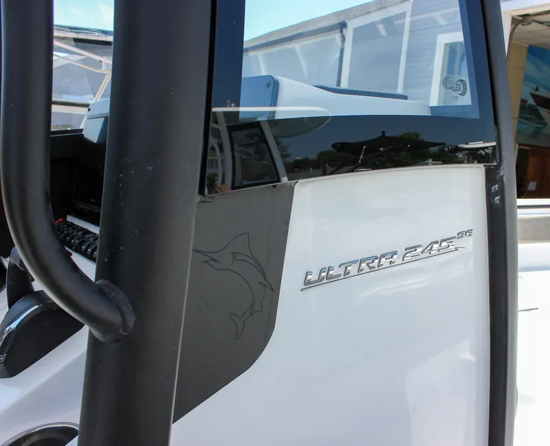 Slide: The Image of 2026 Sea Hunt Ultra 245 SE boat detail with logo and sleek design. - 34