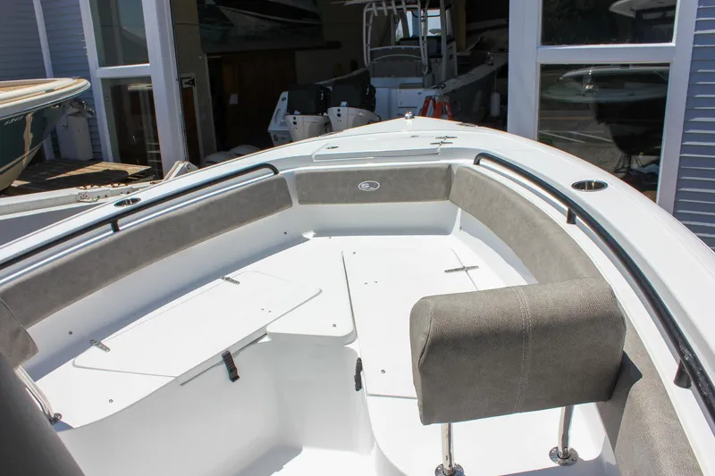 Slide: The Image of 2026 Sea Hunt Ultra 245 SE boat interior with cushioned seating and storage compartments. - 35