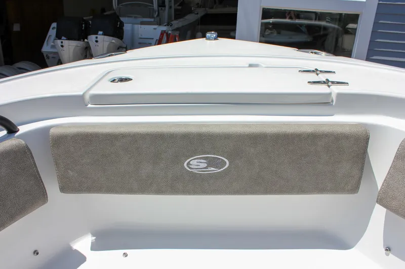 Slide: The Image of 2026 Sea Hunt Ultra 245 SE boat interior with cushioned seating and storage compartments. - 36