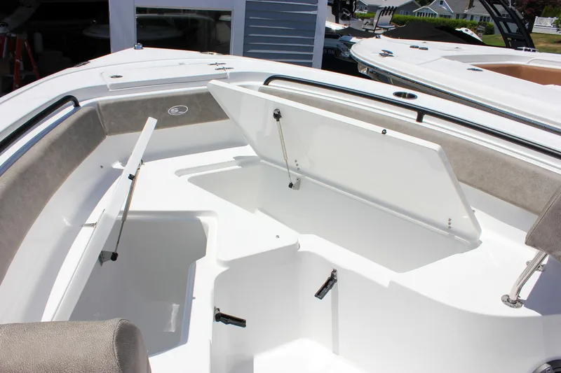 Slide: The Image of 2026 Sea Hunt Ultra 245 SE boat interior with open storage compartments. - 37