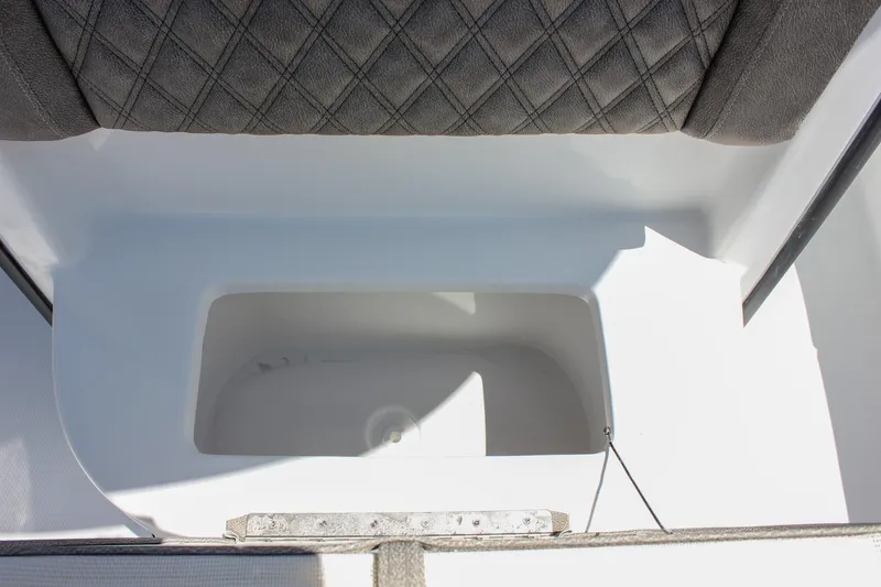 Slide: The Image of 2026 Sea Hunt Ultra 245 SE boat storage compartment with cushioned seating. - 41