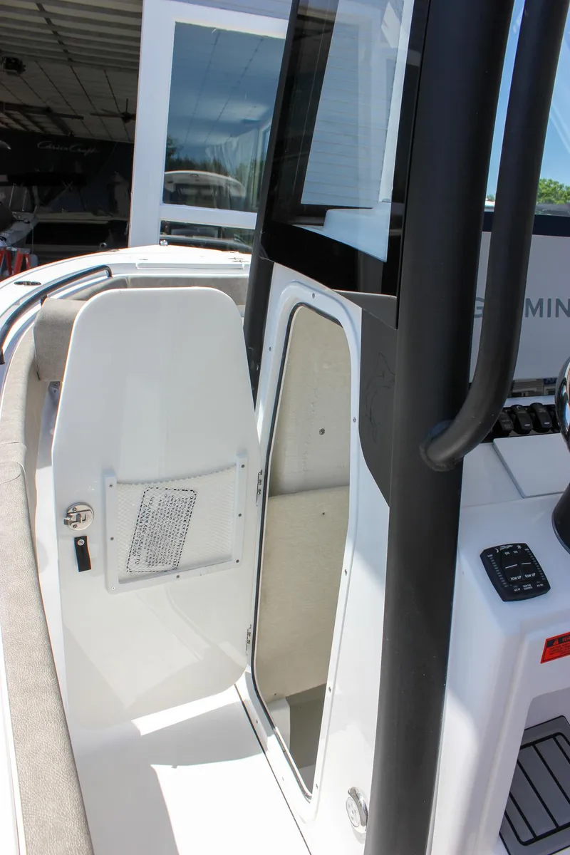 Slide: The Image of 2026 Sea Hunt Ultra 245 SE boat interior with open storage compartment. - 42