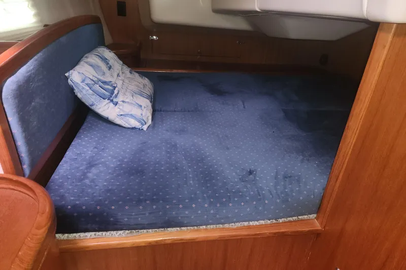 Slide: The Image of Cozy cabin bed with blue bedding in 2004 Hunter 36 sailboat. - 13