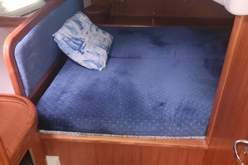Slide: The Image of Cozy cabin bed with blue upholstery in 2004 Hunter 36 sailboat. - 14