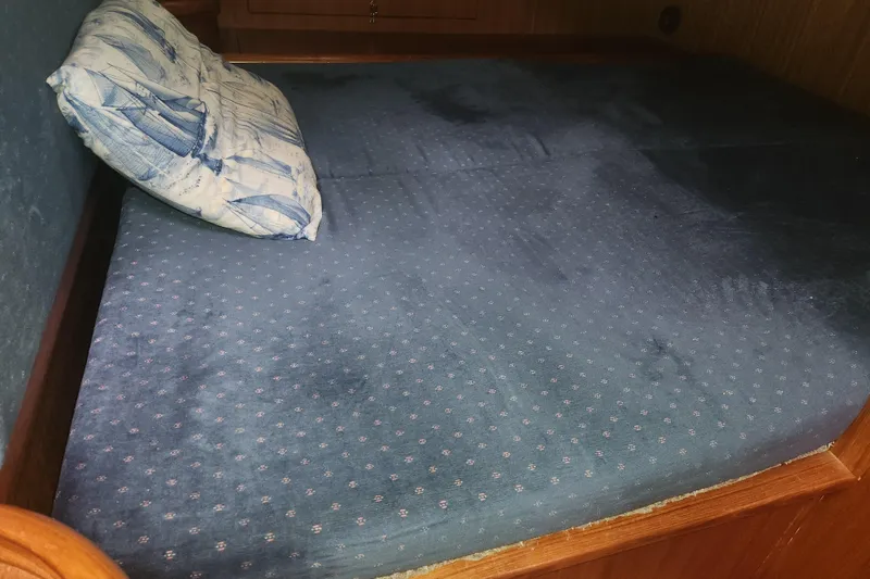 Slide: The Image of Blue mattress with patterned pillow in a 2004 Hunter 36 boat cabin. - 15