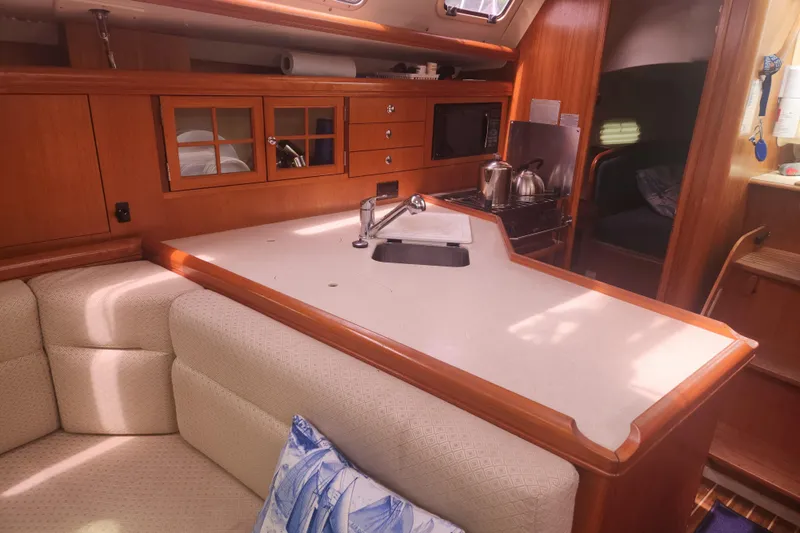 Slide: The Image of Interior of 2004 Hunter 36 sailboat with kitchen and seating area. - 17