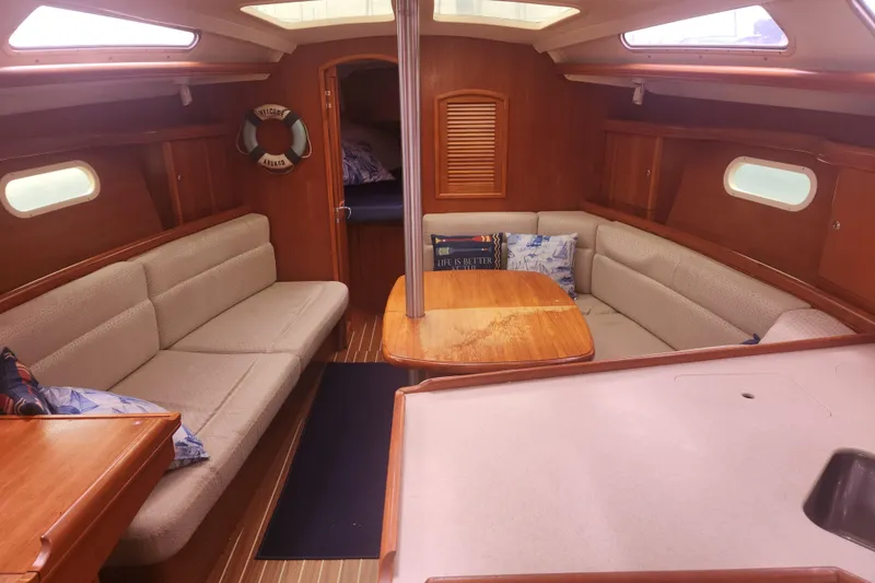 Slide: The Image of Interior of 2004 Hunter 36 sailboat with cozy seating and wooden table. - 19