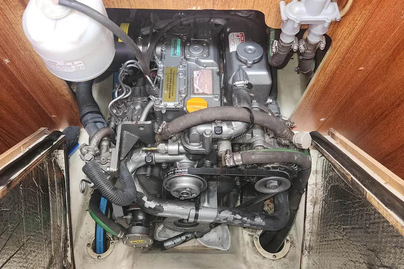 Slide: The Image of Engine compartment of a 2004 Hunter 36 sailboat, showcasing detailed mechanical components. - 24