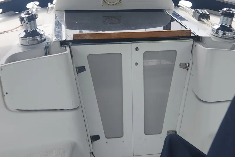 Slide: The Image of Cockpit of 2004 Hunter 36 sailboat with winches and closed companionway doors. - 26