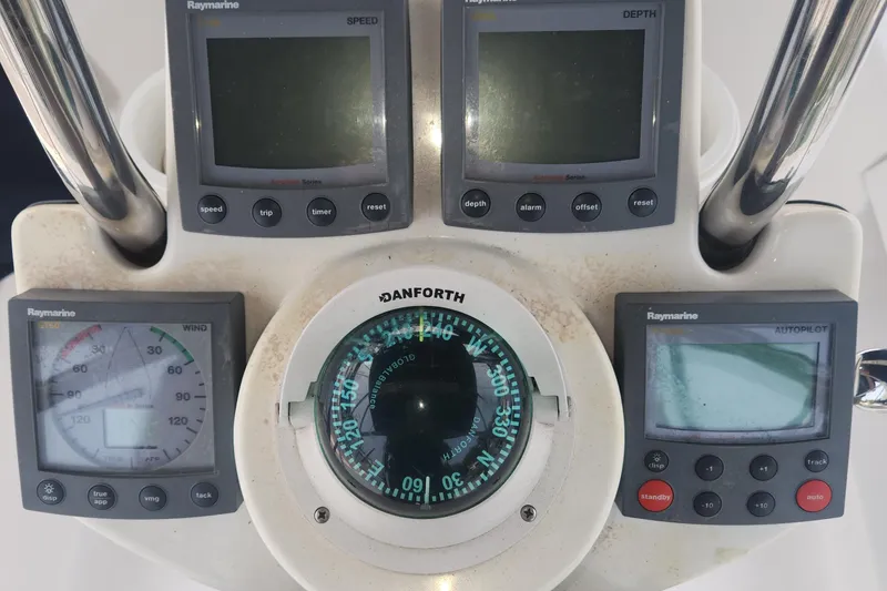 Slide: The Image of Boat navigation instruments on a 2004 Hunter 36, featuring Raymarine displays and Danforth compass. - 28