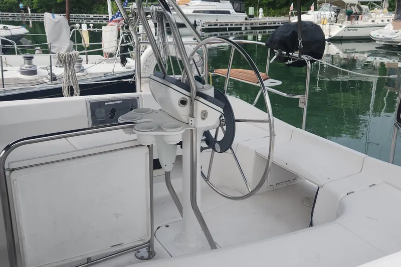 Slide: The Image of Cockpit of a 2004 Hunter 36 sailboat with steering wheel and cup holders. - 29