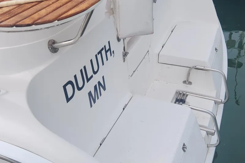 Slide: The Image of 2004 Hunter 36 sailboat with "Duluth, MN" on the stern, docked in water. - 30