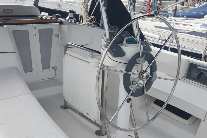 Slide: The Image of Cockpit of a 2004 Hunter 36 sailboat with steering wheel and navigation equipment. - 32