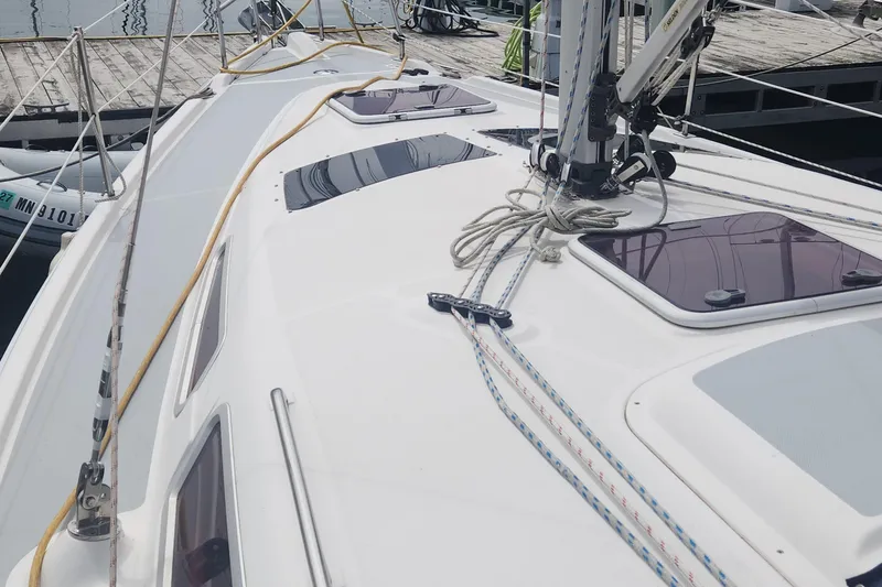 Slide: The Image of Deck view of a 2004 Hunter 36 sailboat docked at a marina. - 33
