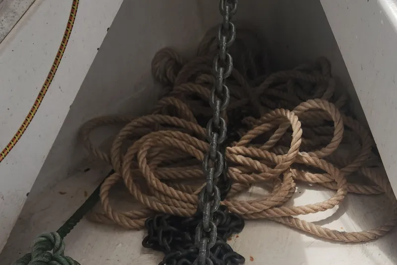 Slide: The Image of Tangled ropes and chain in a 2004 Hunter 36 sailboat compartment. - 37