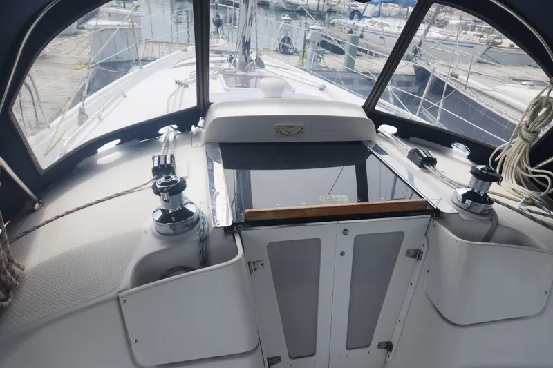 Slide: The Image of Cockpit view of a 2004 Hunter 36 sailboat docked at a marina. - 39